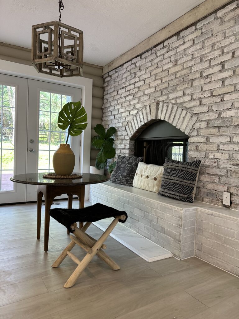 Kitchen fireplace stone feature in white washed brick and updated knee wall with ceramic white tile finish.